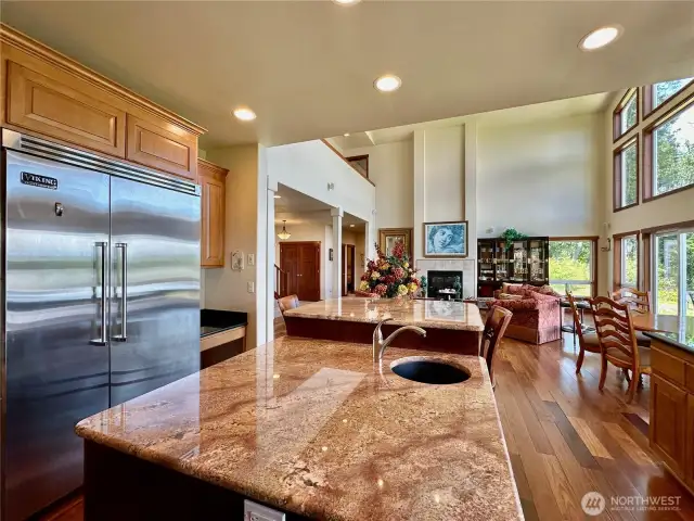 The kitchen has a large window open to the view, granite countertops and a large kitchen island.