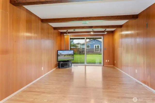 Great room adjacent kitchen with sliders leading to backyard