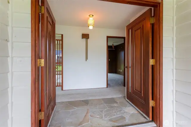 Double doors leading into home with stone entry