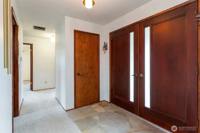 Entryway with closet on left