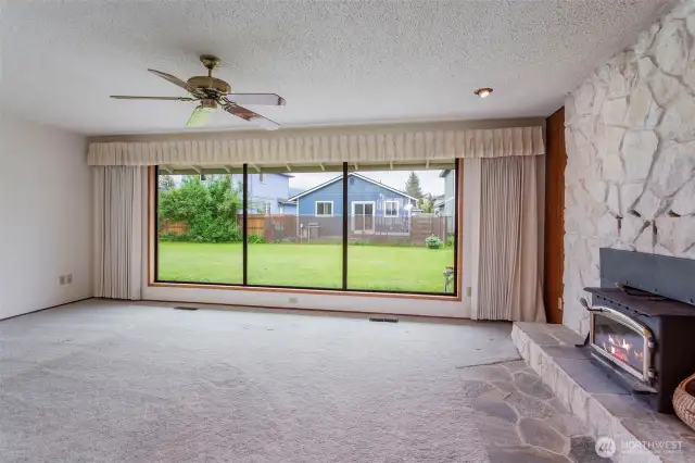 Gorgeous wall of windows, stone fireplace in living room