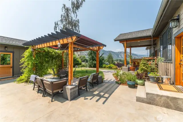 Inviting patio with pergola, detached studio, and direct access to the kitchen—ideal for indoor-outdoor living.