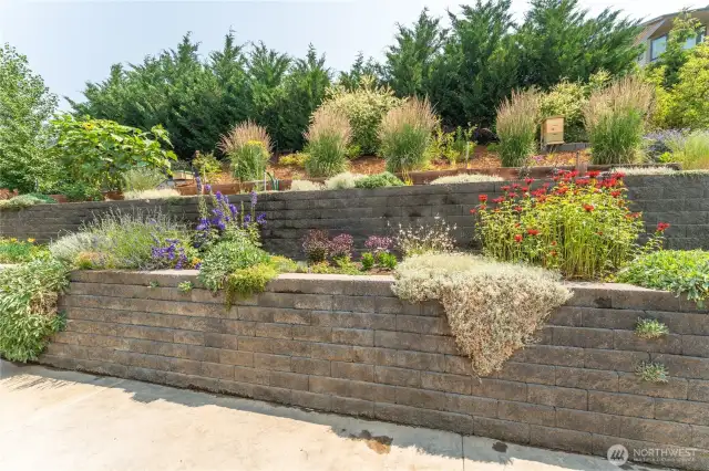Terraced backyard with beautifully maintained garden beds—ideal for outdoor enjoyment and easy upkeep.