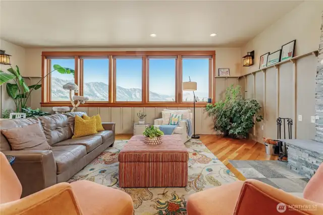 Open-concept living space featuring vaulted ceilings and a stunning wall of windows that capture breathtaking views.