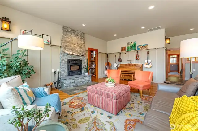 Striking rock wood-burning fireplace anchors the room—perfect for cozy evenings and lively gatherings.