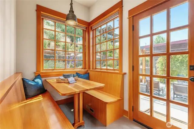 Charming built-in table and bench create a cozy nook for everyday meals and casual gatherings.
