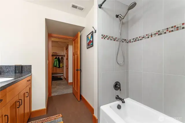 Lower-level full bathroom with tasteful finishes and convenient access.