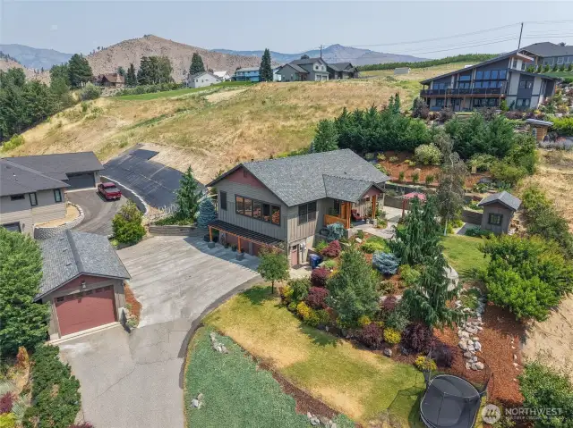 Overhead view captures the full property and its scenic surroundings—showcasing layout, landscaping, and natural beauty.
