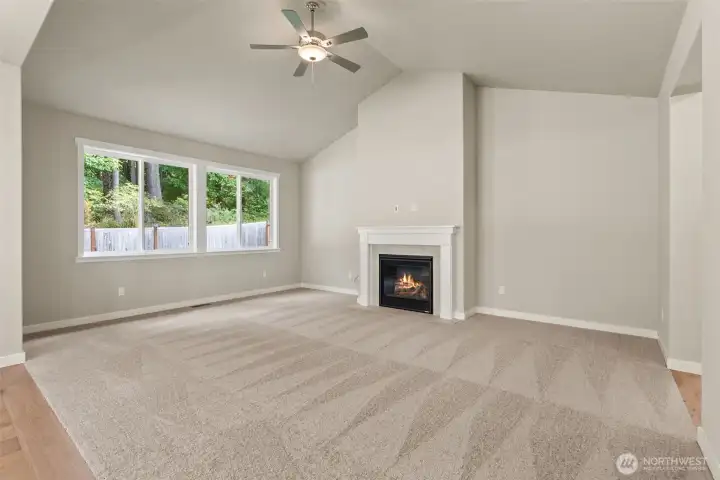 Lovely, vaulted ceilings in living room. Ceiling fans are standard in living rooms and primary bedroom