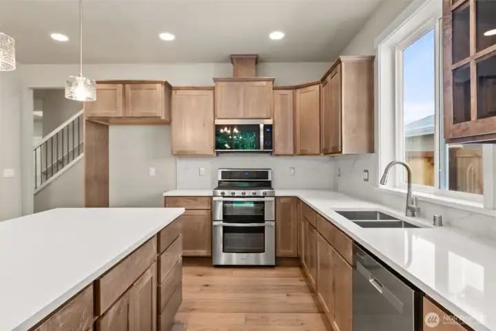 Plenty of storage in these beautiful maple cabinets.