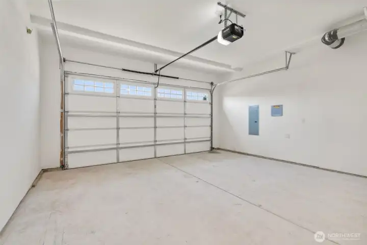 Double car garage is drywalled and includes garage door opener.
