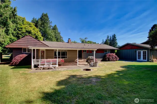 Established back yard with patio and fire pit.