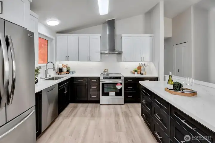Cabinet height solid quartz backsplash with under cabinet lighting.