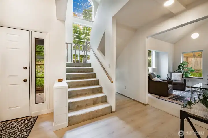 Entry has new floors, soaring ceilings and an open inviting vibe