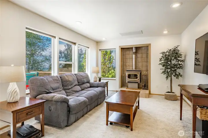 Family Room off kitchen has a cozy fireplace and lots of natural light