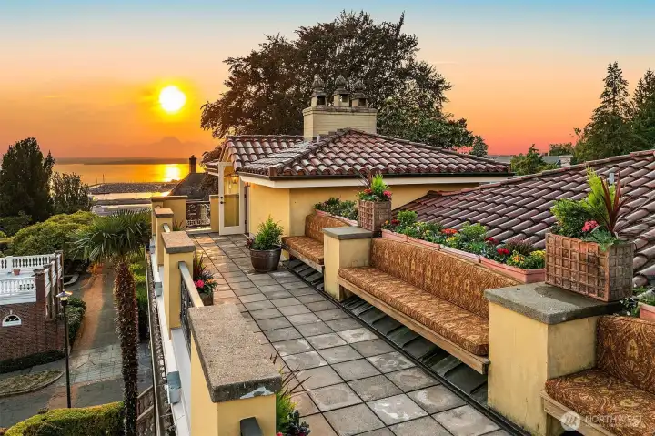 Expansive rooftop deck extends along the south side of house with planter gardens, built-in seating, and breathtaking views of the Seattle city skyline, the Space Needle, Elliott Bay, Mount Rainier, and the Olympic mountain range.