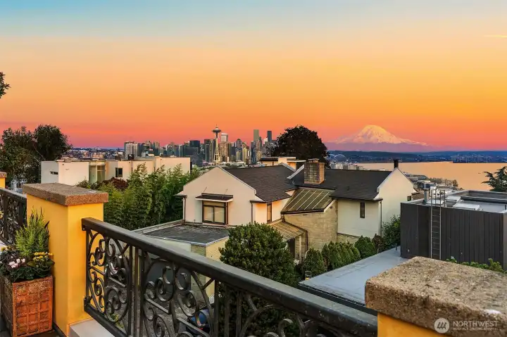 Iconic south-facing view from the rooftop deck of the Seattle city skyline, Mount Rainier, and Puget Sound.