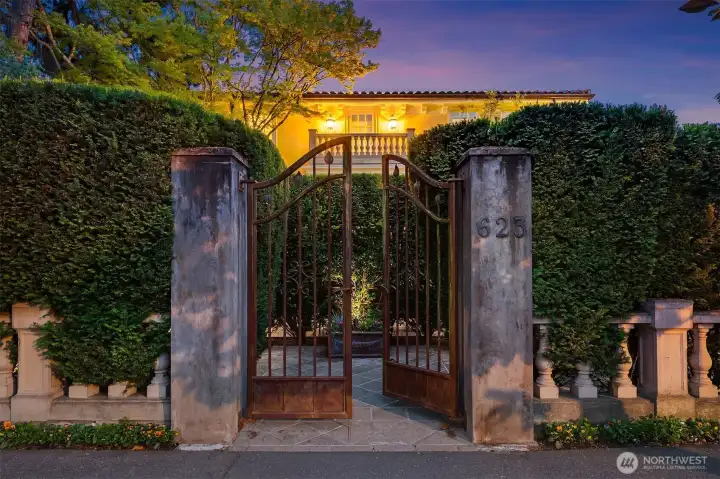 The ornate, wrought-iron gated entry creates a dramatic entrance on West Highland Drive.
