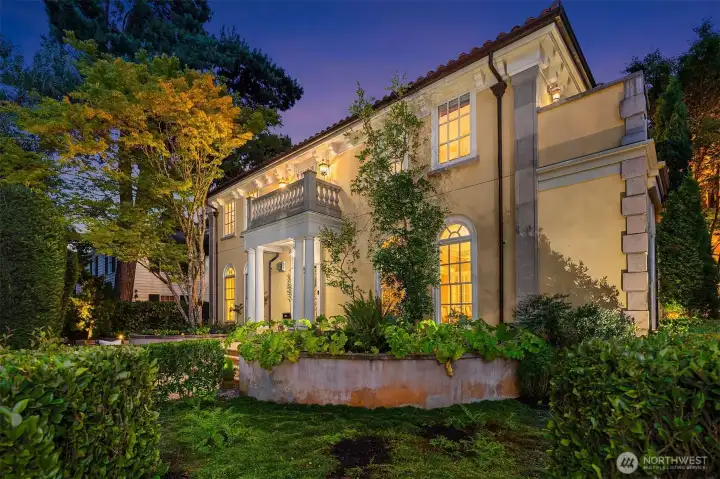 An absolutely stunning home day or night – wall lanterns and landscape lighting create a gorgeous twilight exterior.
