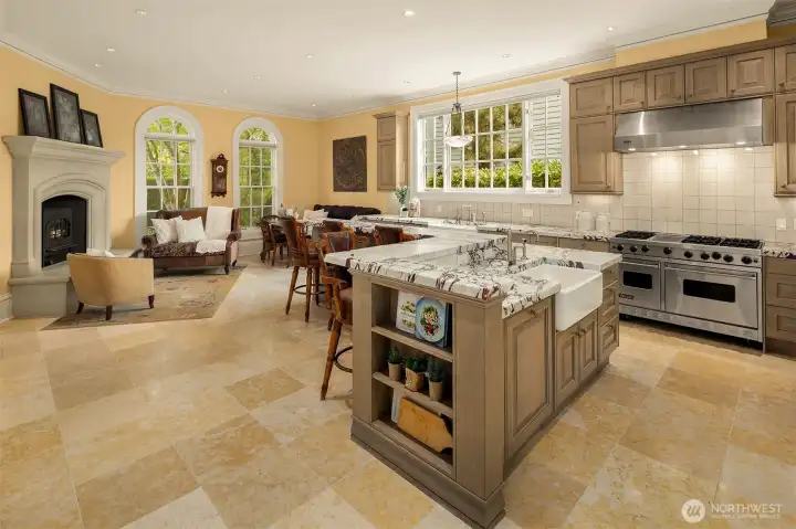 The kitchen opens to a breakfast area and cozy fireside sitting area.