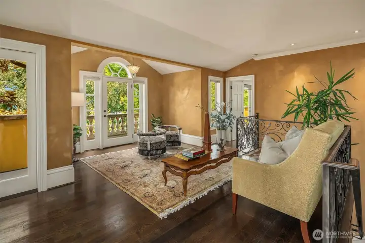 Second floor landing area / sitting room with Juliet balcony and striking dark hardwoods.