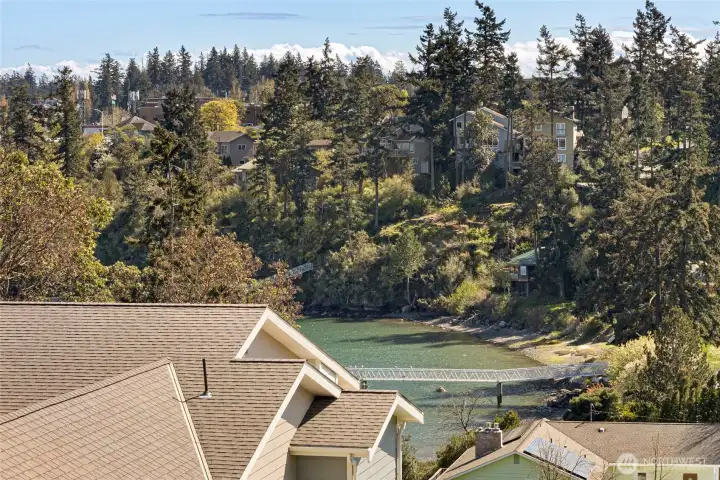 Breathtaking elevated views from the condo showcase the lush Pacific Northwest tree canopy, neighboring rooftops, and a serene glimpse of the water of Friday Harbor Marina. This quintessential San Juan Island scenery is a rare and coveted backdrop for everyday living.