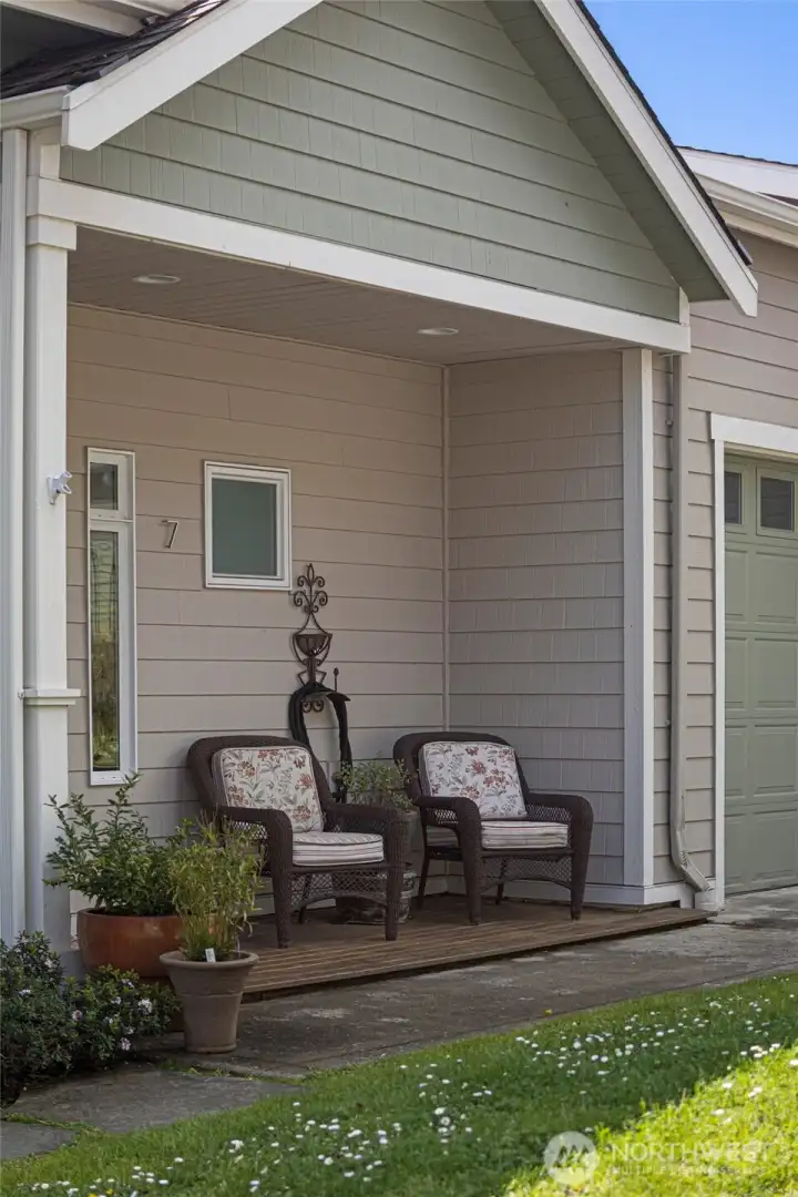 The inviting covered front porch is an ideal spot to unwind. Generous overhead coverage ensures this outdoor space is enjoyable even during the region's occasional misty days.