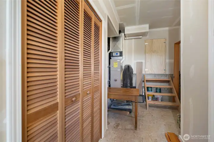 Practical utility and storage area includes louvered closet doors for storage, and a dedicated mechanical and water heater space, ensuring year-round comfort and efficiency.