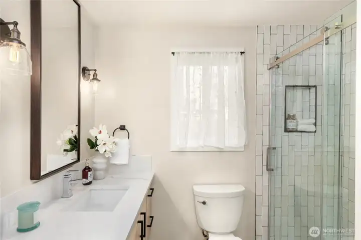 Subway tile shower and sleek floating vanity