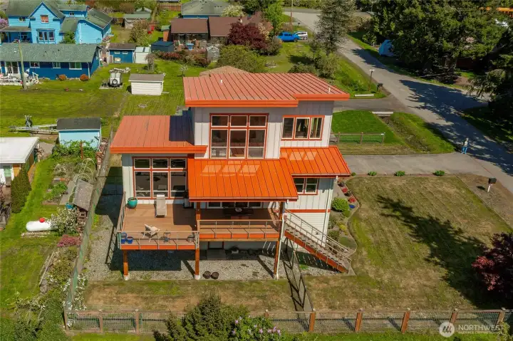 Wall of windows feature wonderful southern sun exposure. Notice the expansive deck with covered and uncovered areas.
