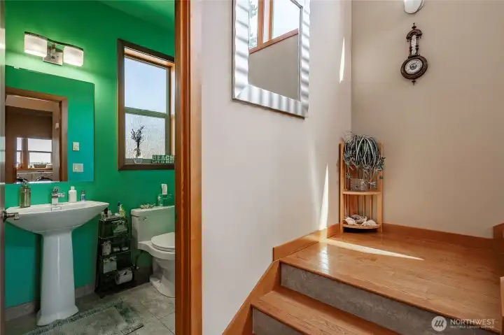 3/4 bath as you come off the garage / shop area. These four foot oak floors with tile facing are solid as a rock and wide enough for a stairlift.