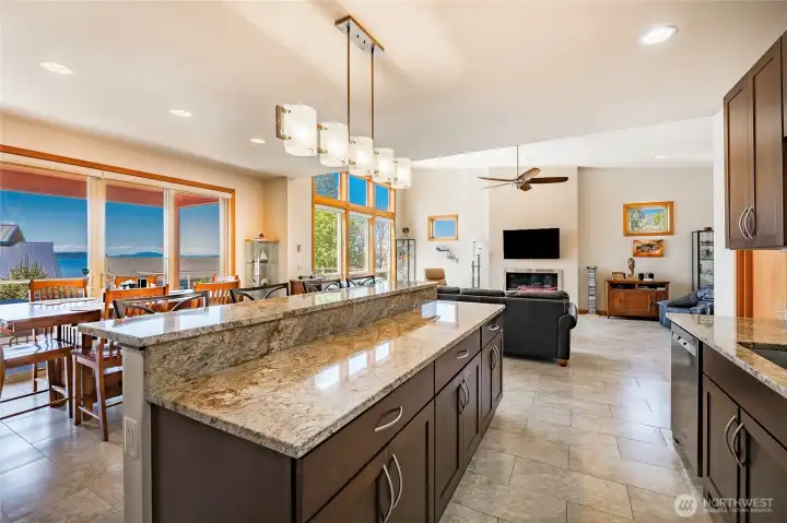 Kitchen and dining open to the great room and deck. Granite countertops, stainless appliances, led lighting, tile floors carried through.