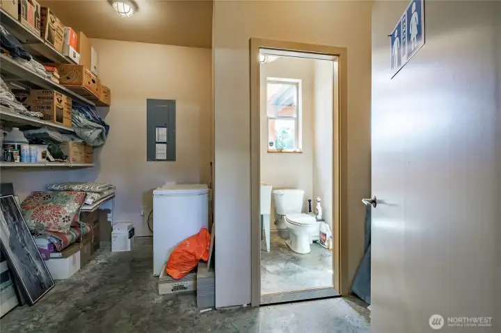 Extra storage area and half bath with sink in the garage / shop area.