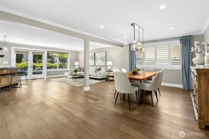 The open family and dining spaces are designed for everyday connection, with expansive windows, warm wood flooring, and effortless flow to the outdoors.