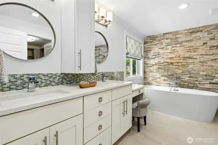 The spa-inspired primary bath pairs clean modern finishes with warm natural textures, creating a space that feels both refined and relaxing.