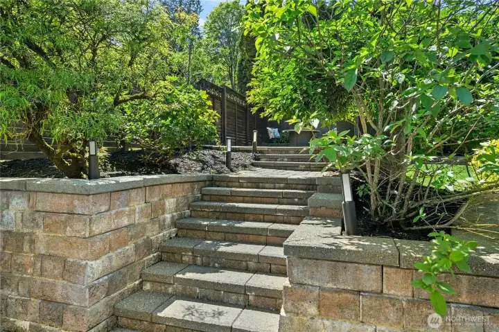 One of several beautifully integrated connections between the lower and upper terraced yard spaces, these stone steps blend function with thoughtful landscape design.
