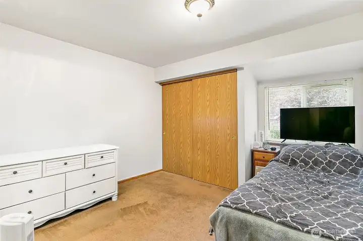 Main bedroom in Unit A is good sized. Photo has been de-staged for tenant privacy