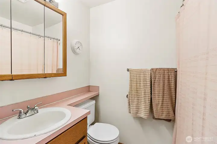 Attached bath in Unit A. Photo has been de-staged for tenant privacy