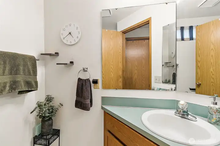 Second half bath in Unit A. Photo has been de-staged for tenant privacy