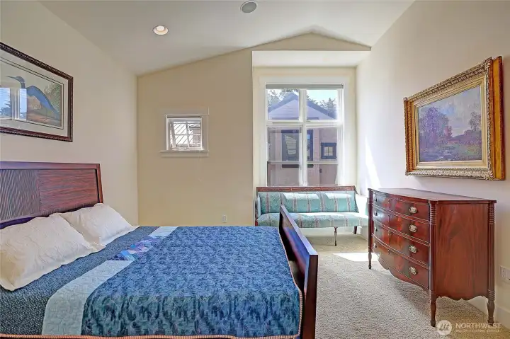 Primary bedroom - vaulted ceilings & tons of natural light.