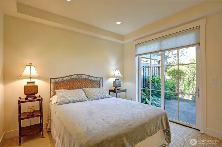 Guest bedroom w/ patio access.