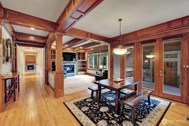 View from kitchen to breakfast nook and  informal living room with den down the hallway. Warm wood accents thru out this home lend to a comforting feeling.