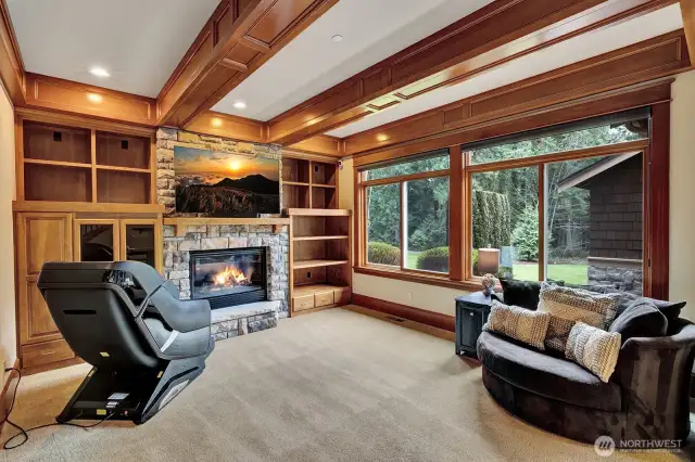 Relax in your informal family room by the rustic stone fireplace accented with warm woods while enjoying natures beauty.