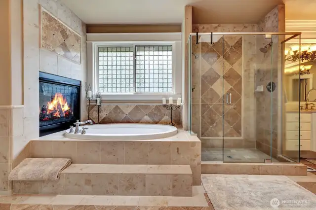 Sunken tub with gas fireplace to relax by.