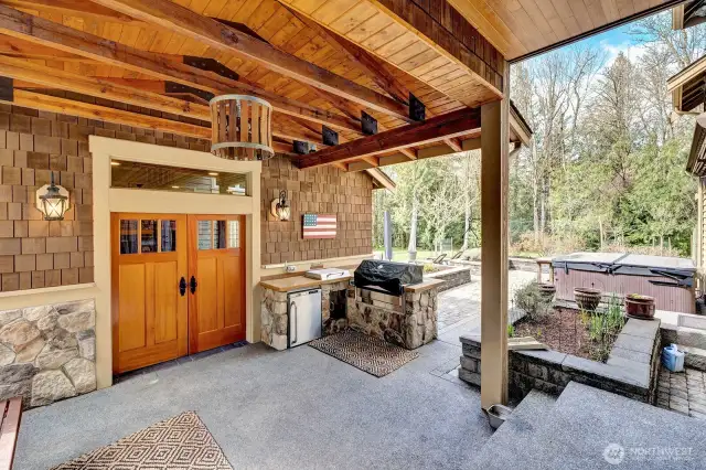 Covered BBQ area leading to the outdoor cabana for relaxation or entertaining.