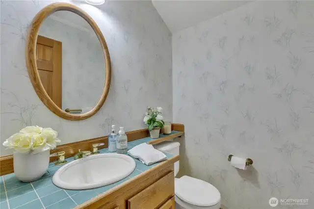 The main level half bath is convenient, offering easy access for guests.