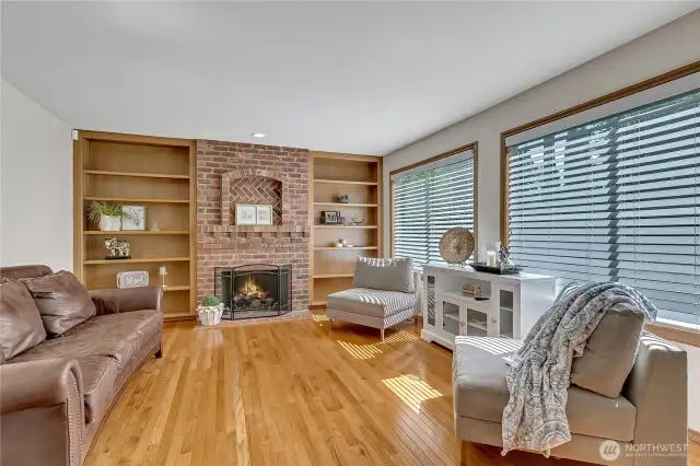 Main level gathering room with gas fireplace adjacent to the kitchen.