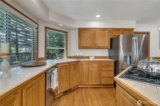 Large windows in the kitchen offer stunning views of the beautiful backyard, flooding the space with natural light. It's the perfect spot to enjoy the scenery while cooking or relaxing.