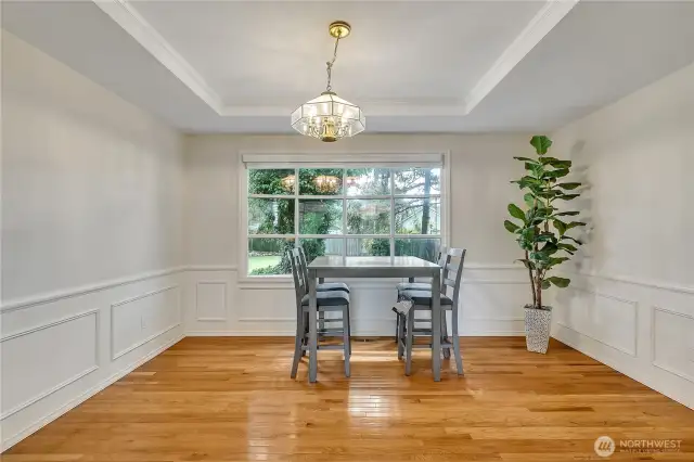 The large dining room bay window offers the perfect view of the outdoors, filling the space with natural light. It creates a bright and inviting atmosphere for every meal.