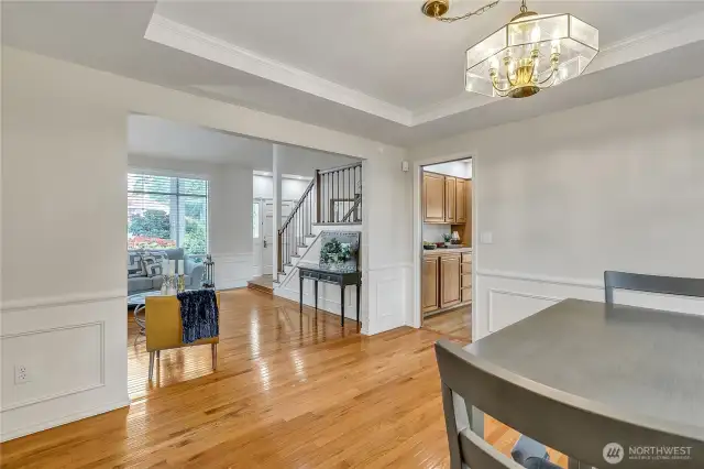 The dining room features a discreet pocket door that leads seamlessly into the kitchen, combining style with functionality. It's a thoughtful detail that enhances flow while maintaining the room’s formal charm.